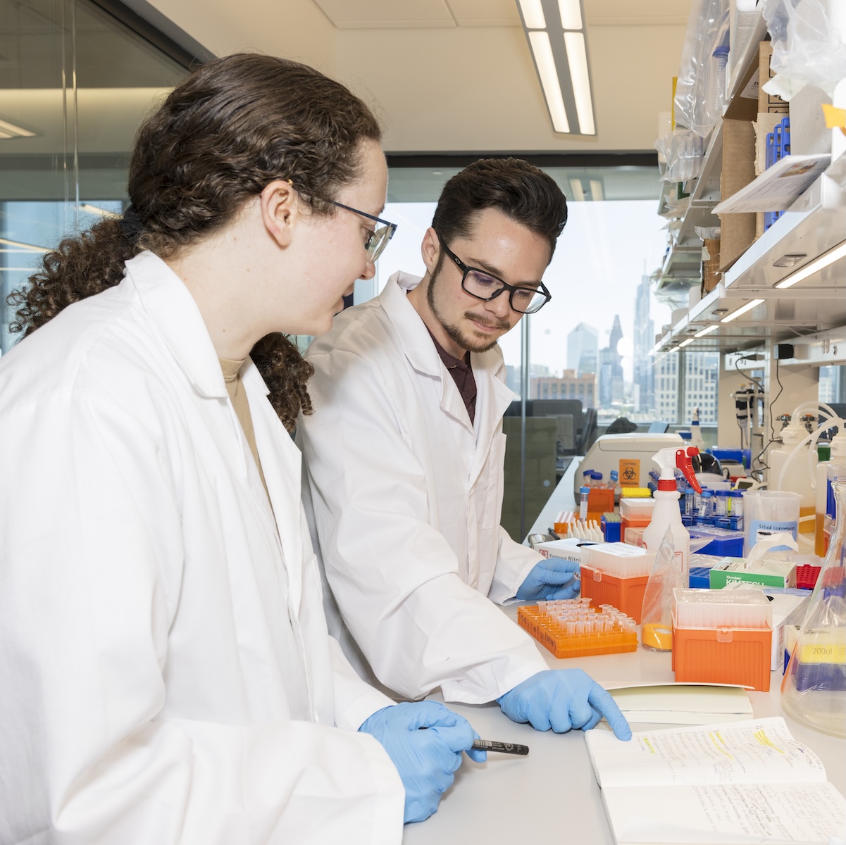 Two researchers compare notes in professor Sherry Gao's lab at Penn Engineering